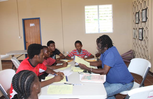 Justin “Hero” Caslell, renowned Montserratian Calypsonian and Soca Artist and facilitator of a Calypso Writing Workshop on Nevis in session with junior calypsonians for the second day at the Hardtimes Community Centre on April 19, 2017